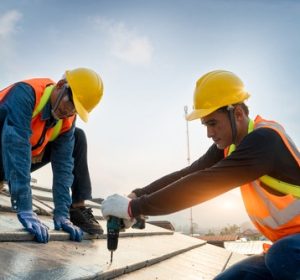 Construction workers working on a roof